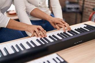 piano teacher and student
sitting at a piano